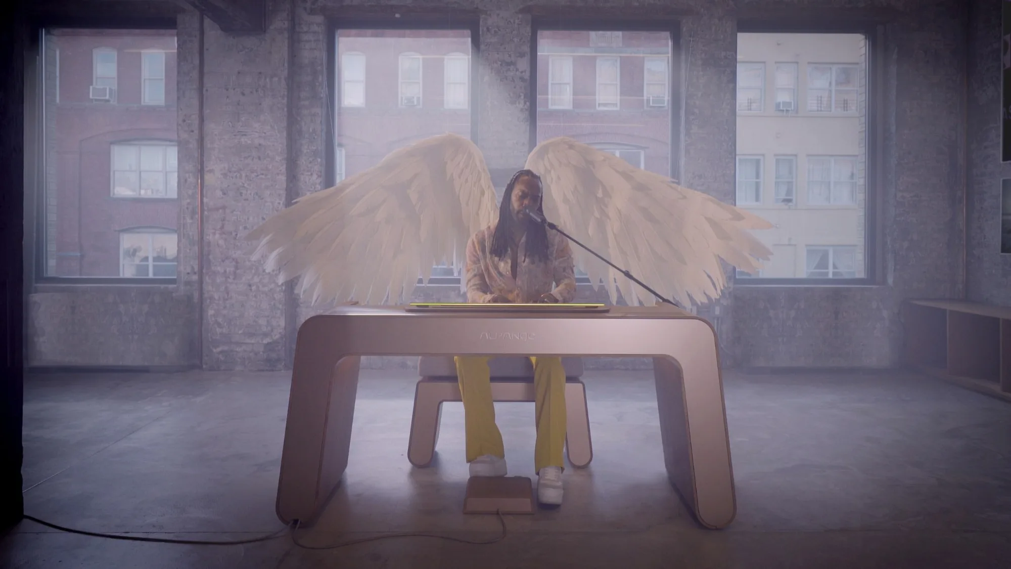 Aaron Marcellus at the Alpange, with wings and a microphone